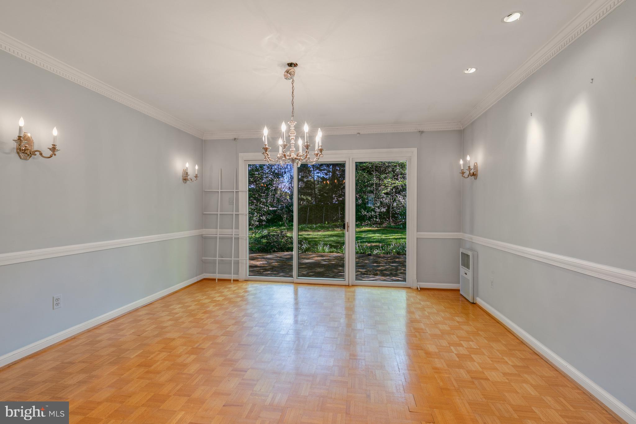 6315 Stoneham Lane McLean, VA 22101 - Photo 6 of 18 a view of an empty room with wooden floor and a window