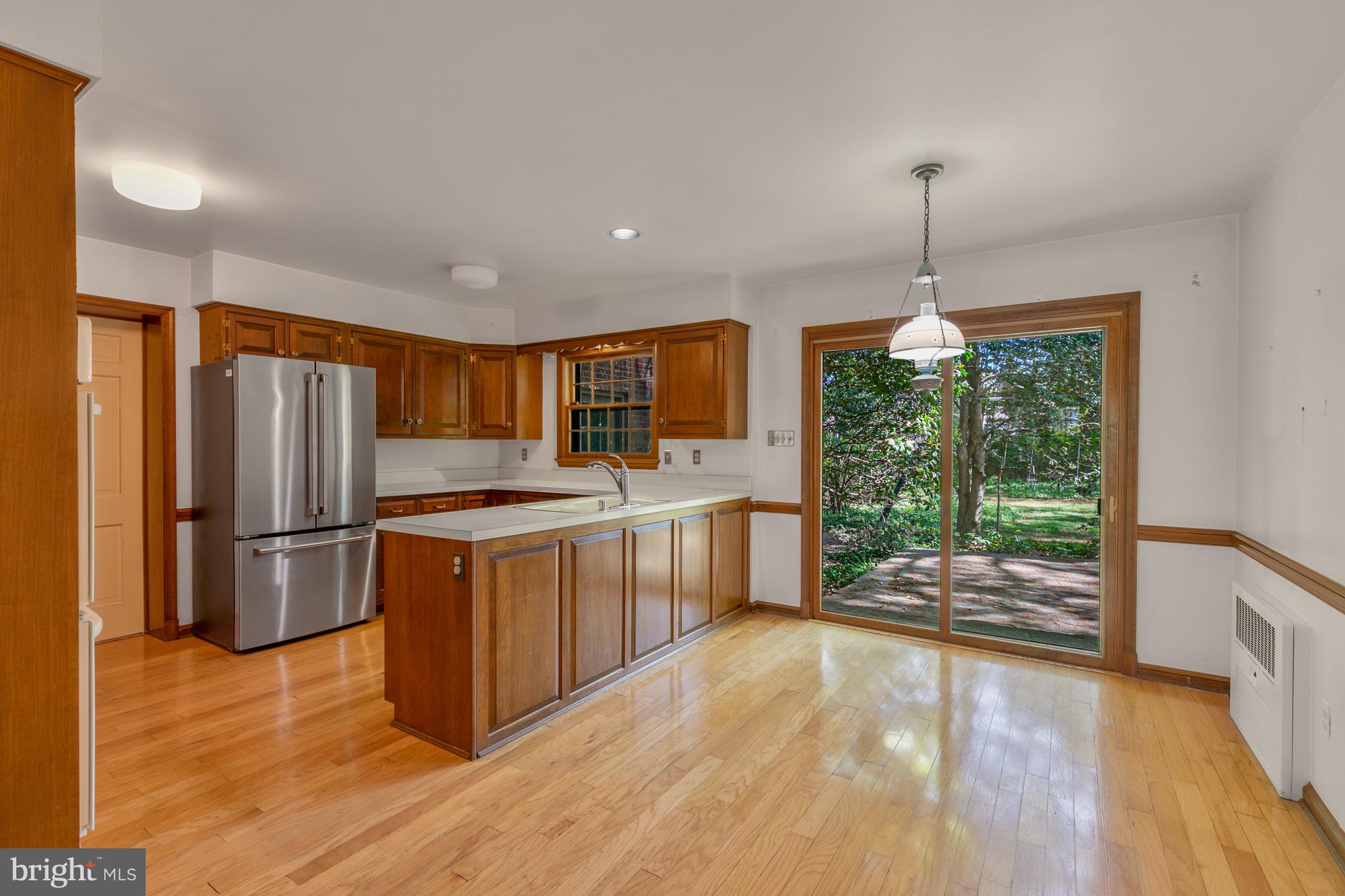 6315 Stoneham Lane McLean, VA 22101 - Photo 8 of 18 a kitchen with stainless steel appliances granite countertop a refrigerator a sink dishwasher a stove and a large countertops with wooden floor