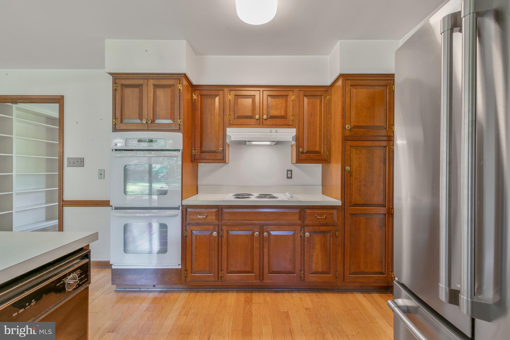 6315 Stoneham Lane McLean, VA 22101 - Photo 9 of 18 a kitchen with stainless steel appliances granite countertop a refrigerator and a stove top oven