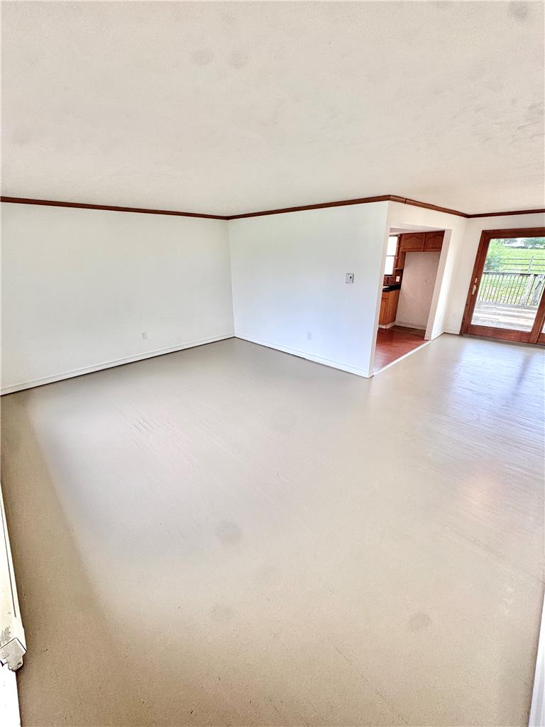 8325 Schantz Road Breinigsville, PA 18031 - Photo 3 of 21 A spacious living area awaits your personal touch, connecting seamlessly to a kitchen and outdoor deck.