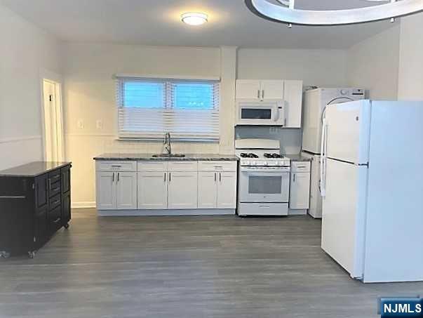 a kitchen with a white cabinets and white appliances