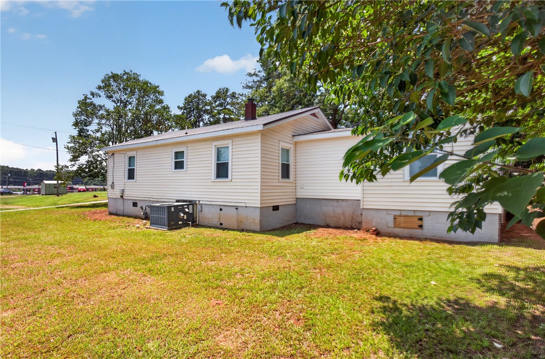 115 Pelfrey Street Seneca, SC 29672 - Photo 36 of 46 A well-maintained structure with light siding and a sprawling lawn, offering abundant outdoor space.