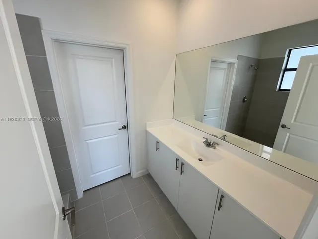a bathroom with a double vanity sink and mirror