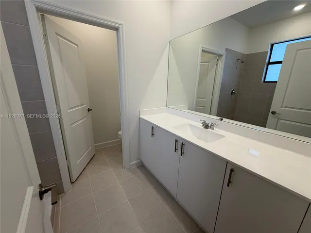 a bathroom with a double vanity sink and mirror