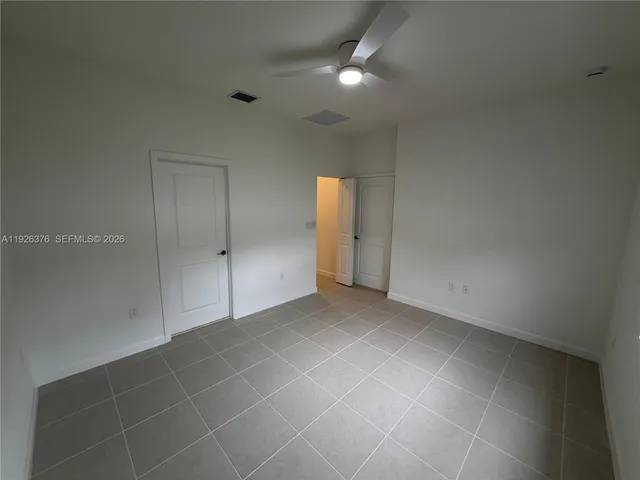 an empty room with an entryway and shower