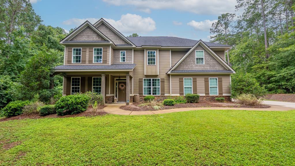a front view of a house with a yard and porch