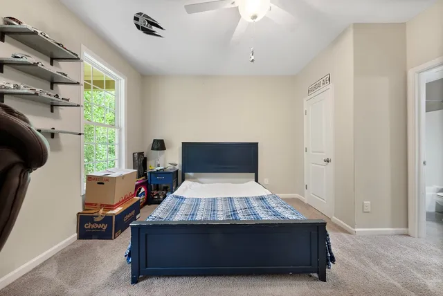 a bed sitting in a room next to a window