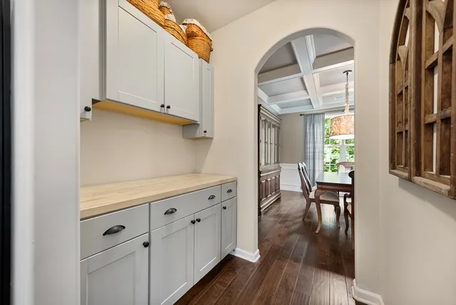 a view of hallway with furniture and wooden floor