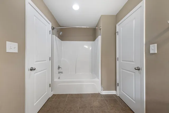 a bathroom with a tub shower vanity and a sink
