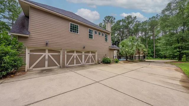 a view of garage with wooden door and seating space