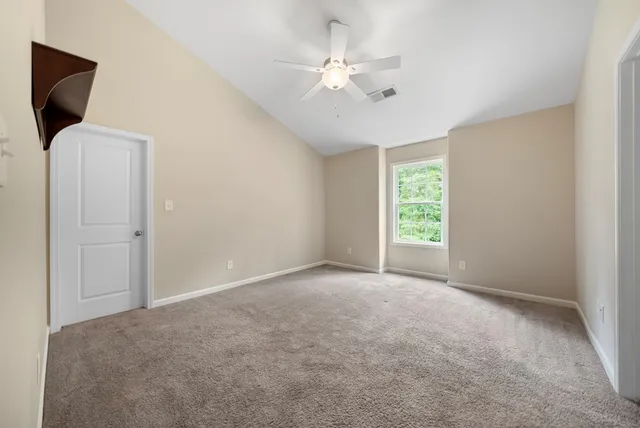 a view of a livingroom with a ceiling fan and window