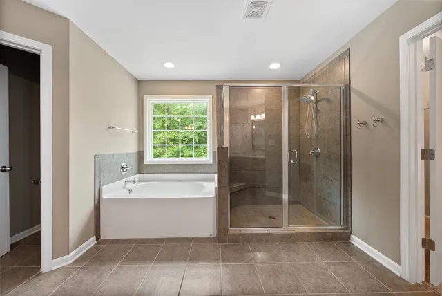 a bathroom with a bathtub and a shower