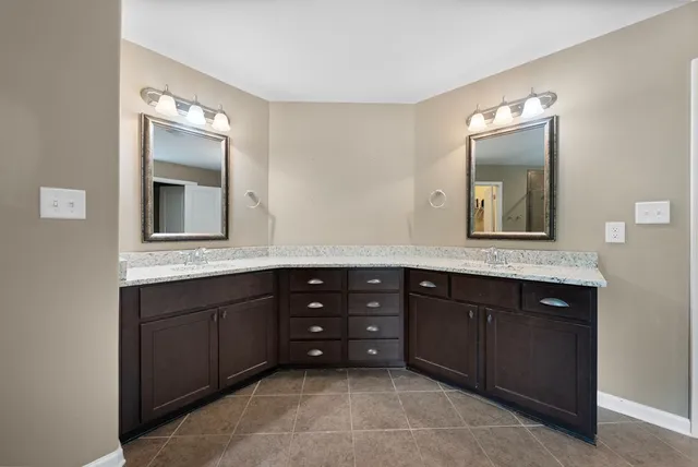 a bathroom with a vanity sink and mirror bathtub