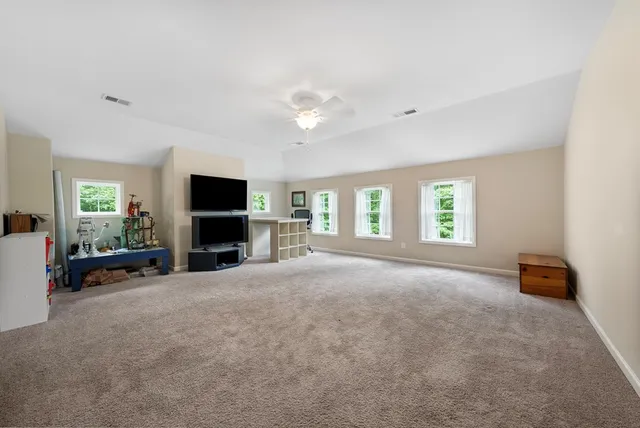 a view of empty room with furniture and a flat screen tv