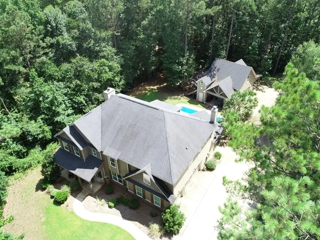 an aerial view of a house with yard
