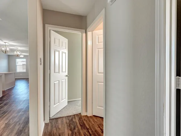a view of hallway with wooden floor