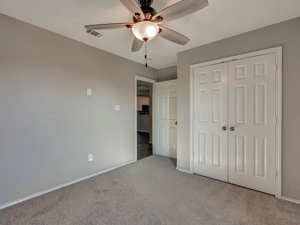 a view of a room with a ceiling fan and a chandelier fan