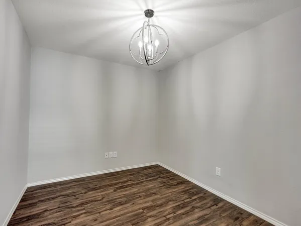 a view of a chandelier fan and wooden floor