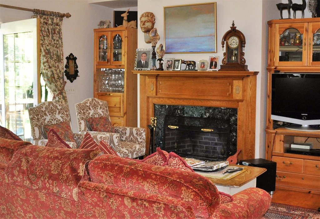 16 Baker Road Wellfleet, MA 02667 - Photo 8 of 25 a living room with furniture a flat screen tv and a fireplace
