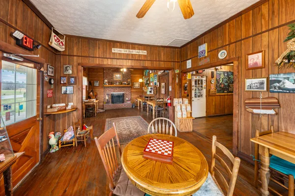 a view of a white house with a yard and sitting area