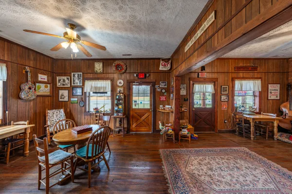 a view of a house with a yard and tree s