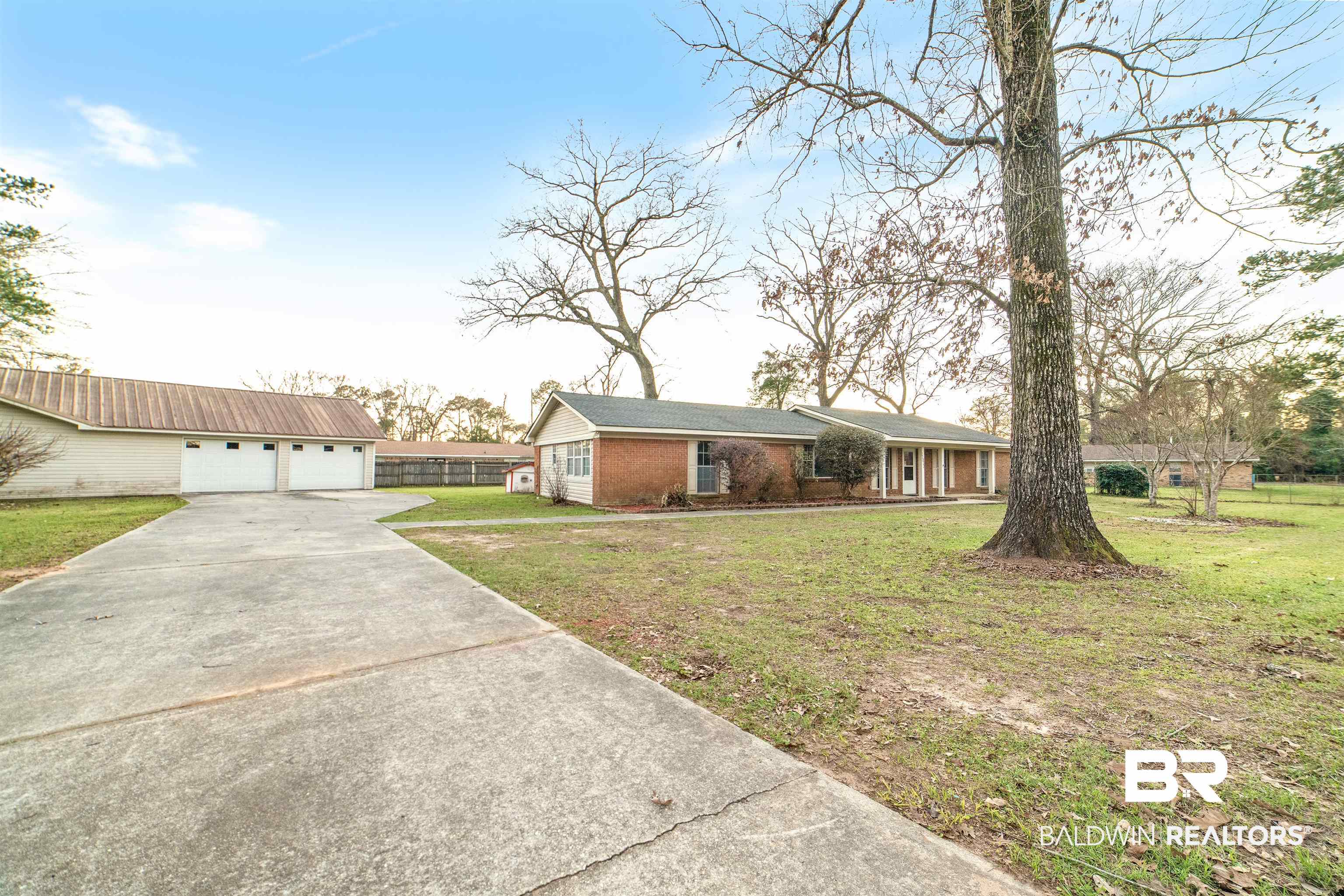 11833 Old Moffat Road Wilmer, AL 36587 - Photo 20 of 23 Ranch-style house featuring a garage, a front lawn, and brick siding