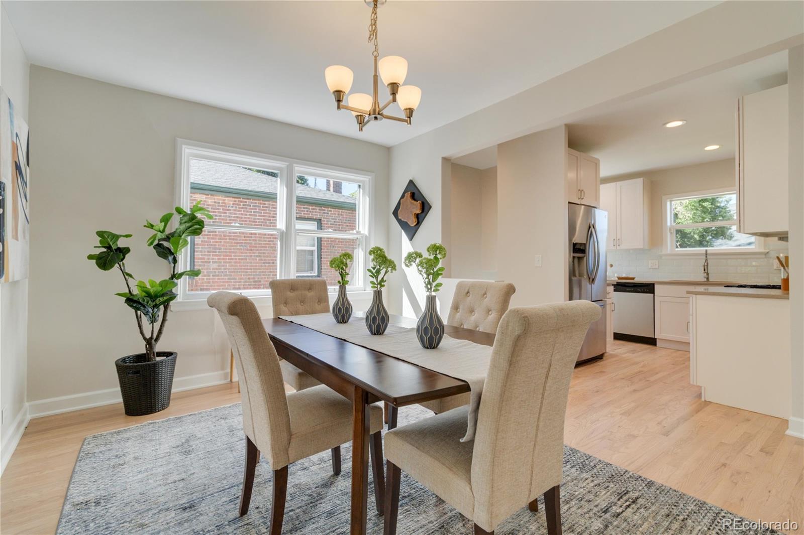 1325 Dahlia Street Denver, CO 80220 - Photo 12 of 44 a dining room with furniture potted plants and wooden floor