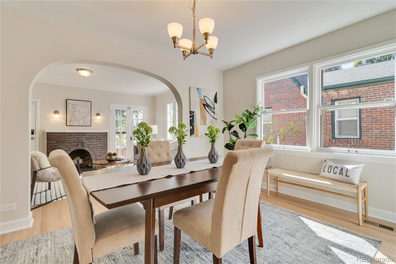 1325 Dahlia Street Denver, CO 80220 - Photo 14 of 44 a view of a dining room with furniture a chandelier and wooden floor
