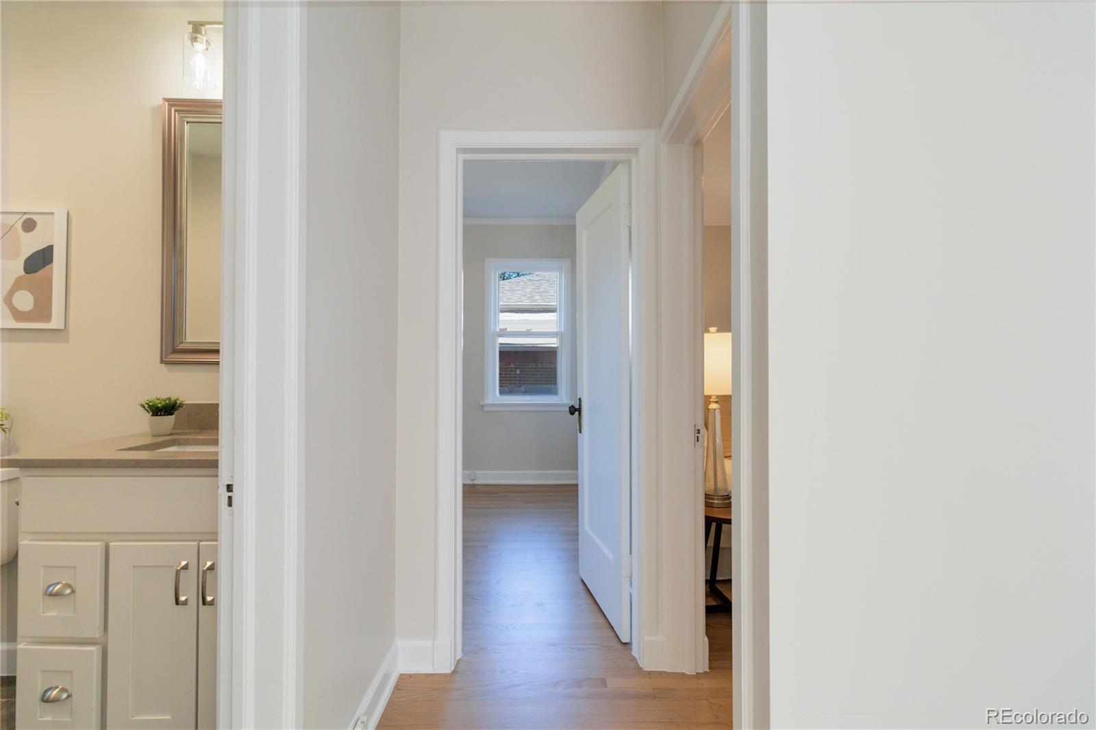 1325 Dahlia Street Denver, CO 80220 - Photo 19 of 44 a view of a hallway with wooden floor