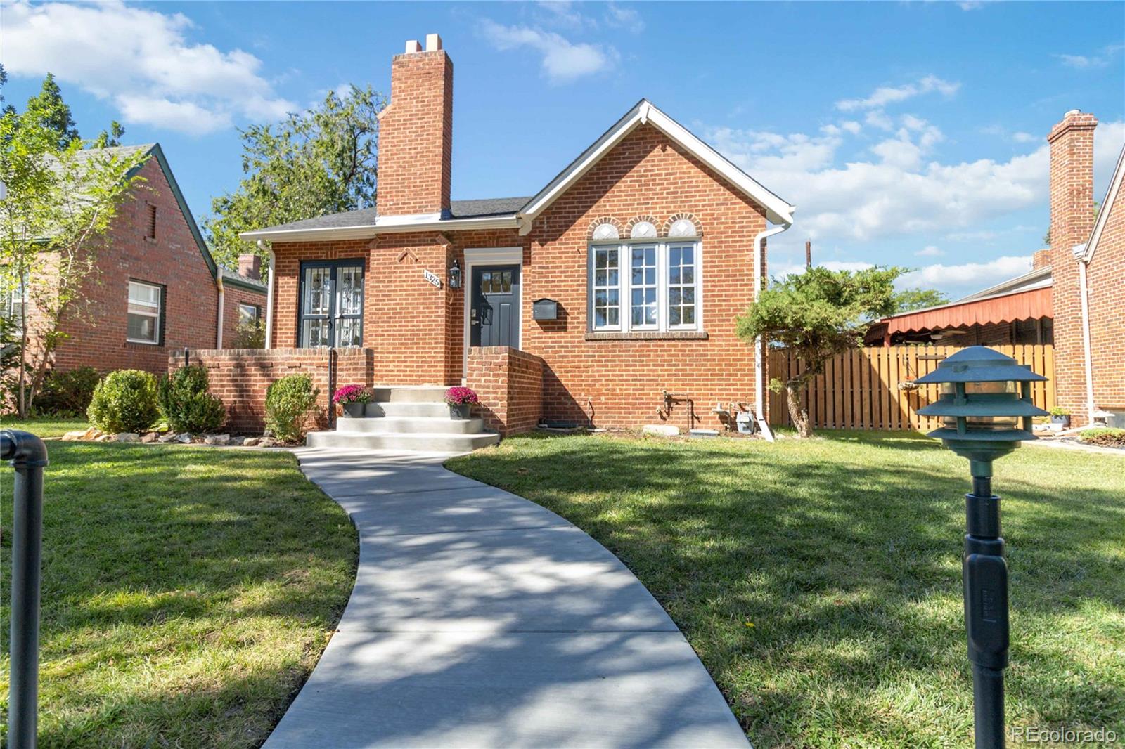 1325 Dahlia Street Denver, CO 80220 - Photo 2 of 44 a front view of a house with garden