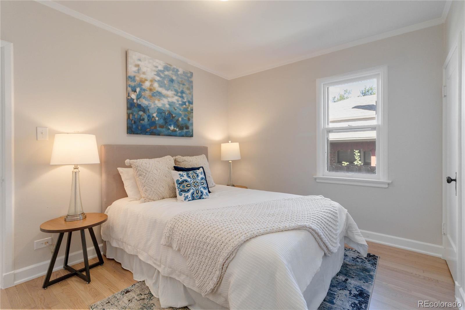 1325 Dahlia Street Denver, CO 80220 - Photo 23 of 44 a bedroom with a bed and a lamp