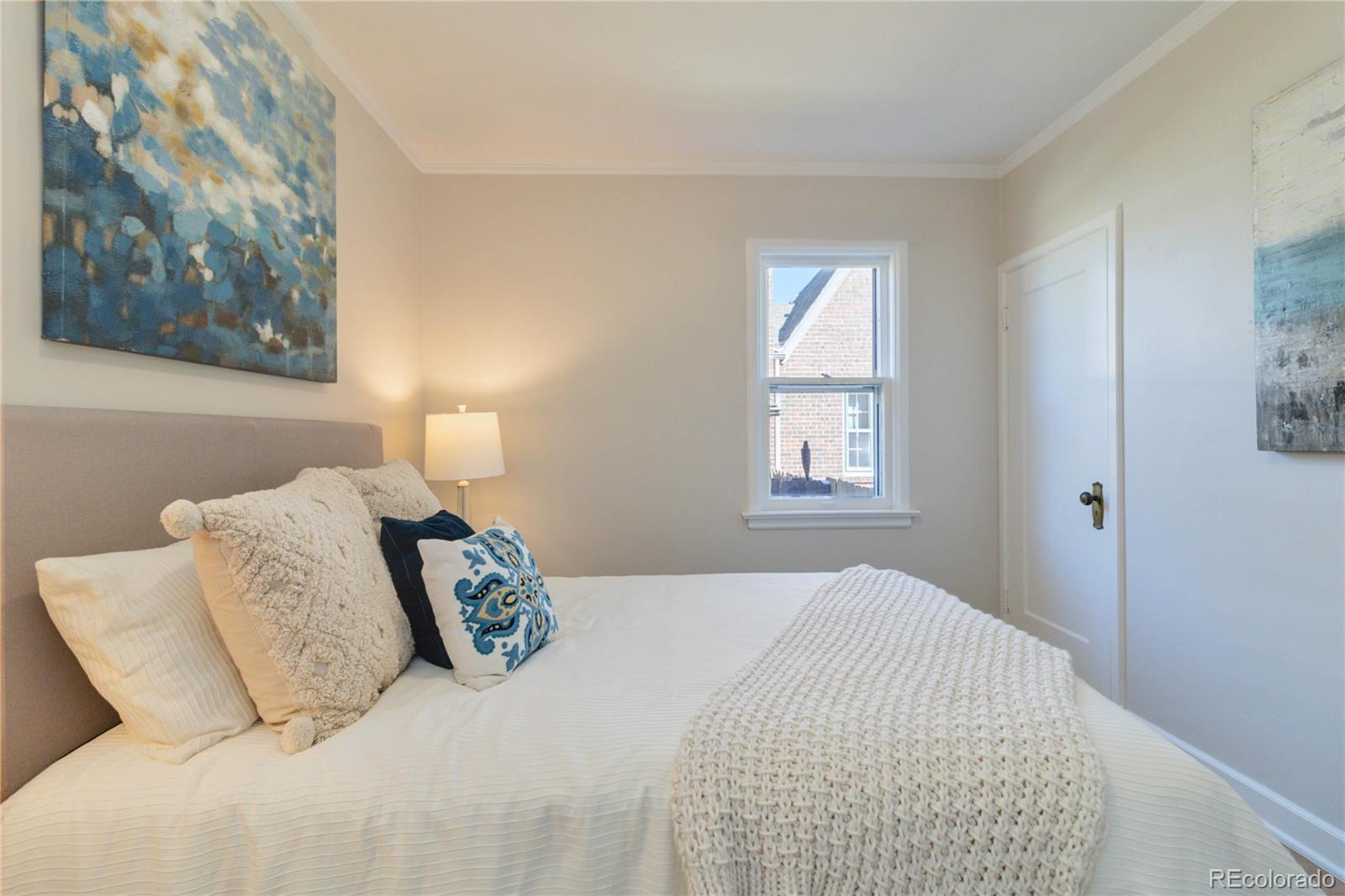 1325 Dahlia Street Denver, CO 80220 - Photo 25 of 44 a bedroom with a bed and a painting on the wall