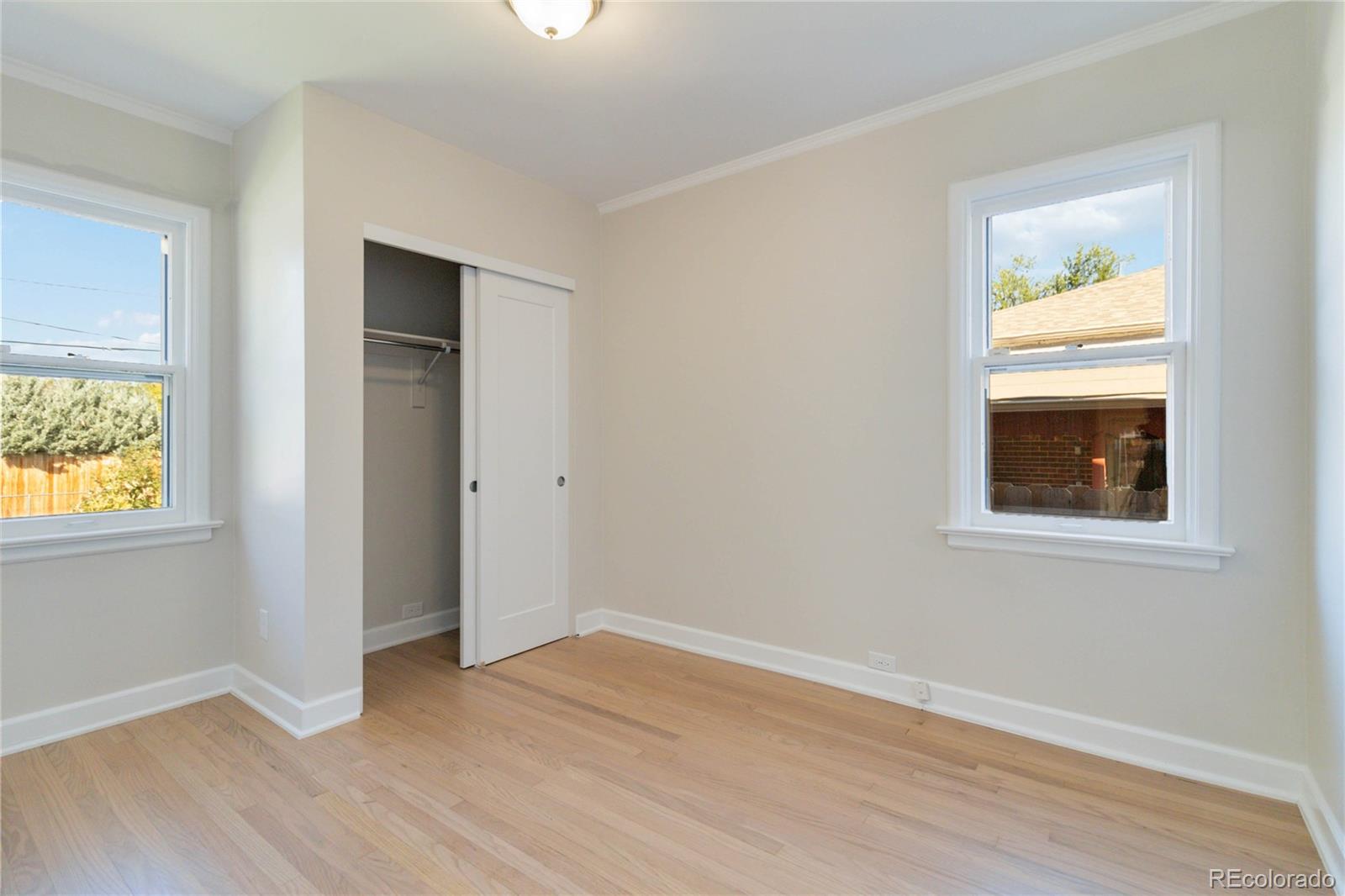 1325 Dahlia Street Denver, CO 80220 - Photo 26 of 44 an empty room with wooden floor and windows