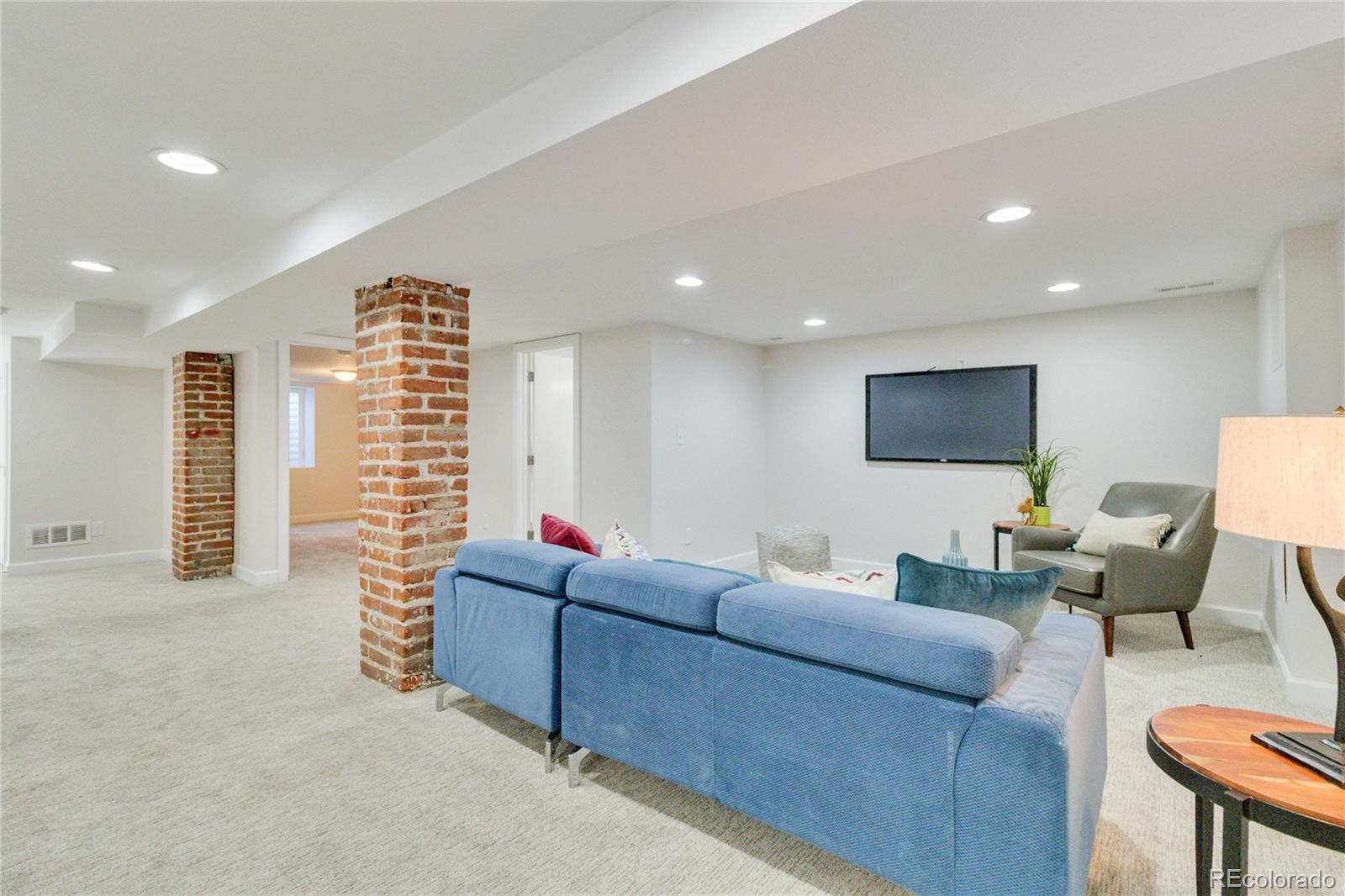 1325 Dahlia Street Denver, CO 80220 - Photo 30 of 44 a living room with furniture and a flat screen tv