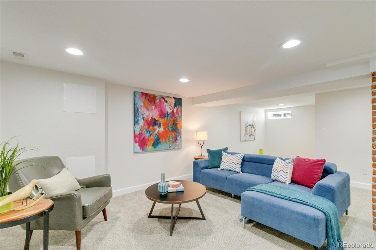 1325 Dahlia Street Denver, CO 80220 - Photo 32 of 44 a living room with furniture and a rug