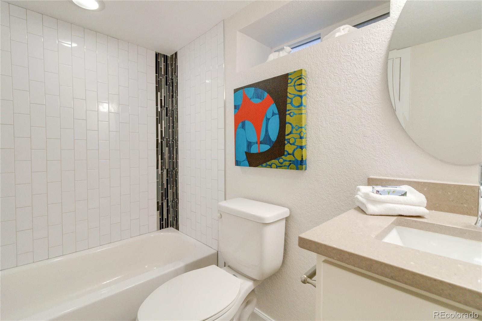 1325 Dahlia Street Denver, CO 80220 - Photo 33 of 44 a bathroom with a toilet a sink and bathtub