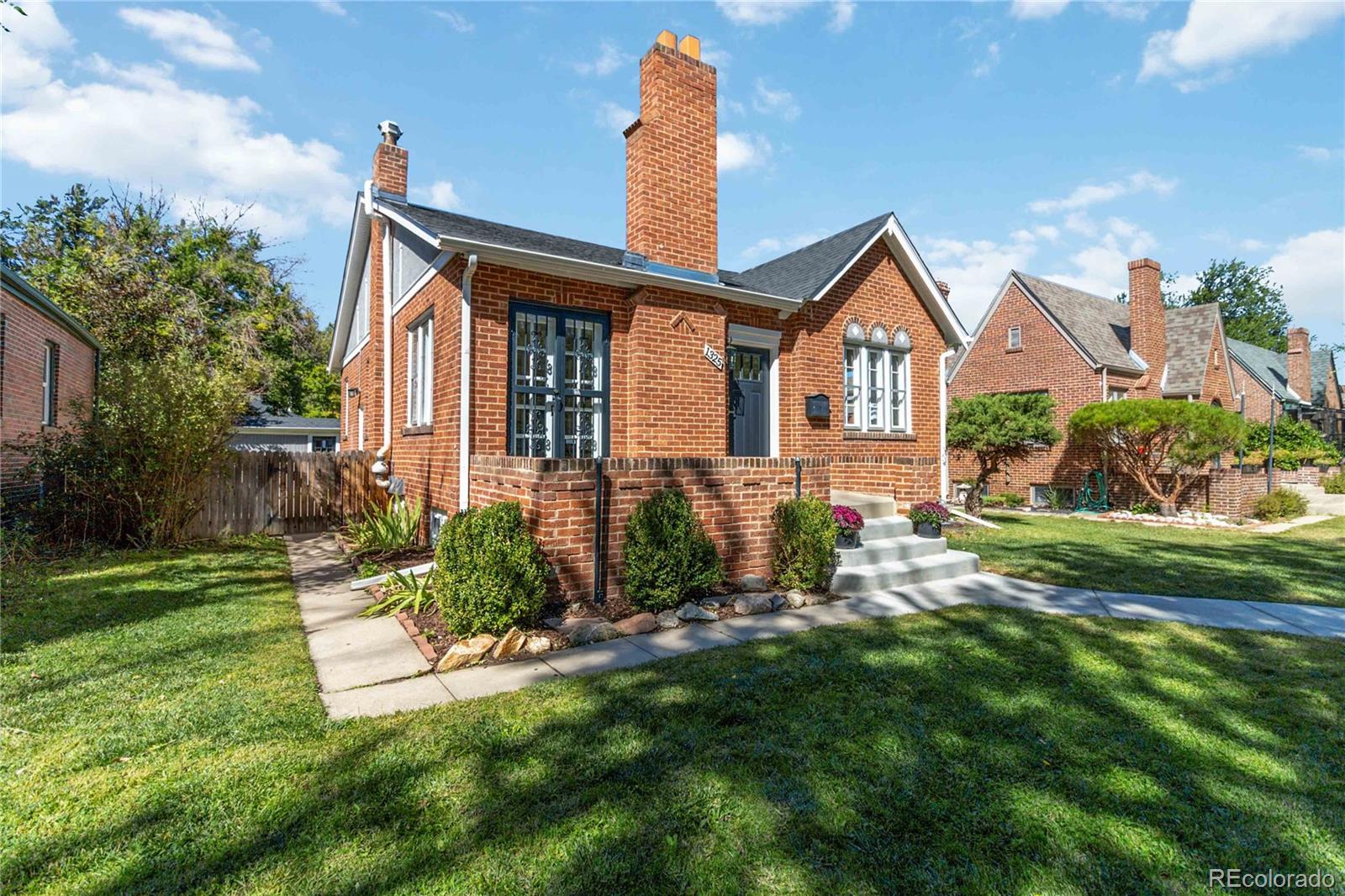 1325 Dahlia Street Denver, CO 80220 - Photo 43 of 44 a front view of a house with garden