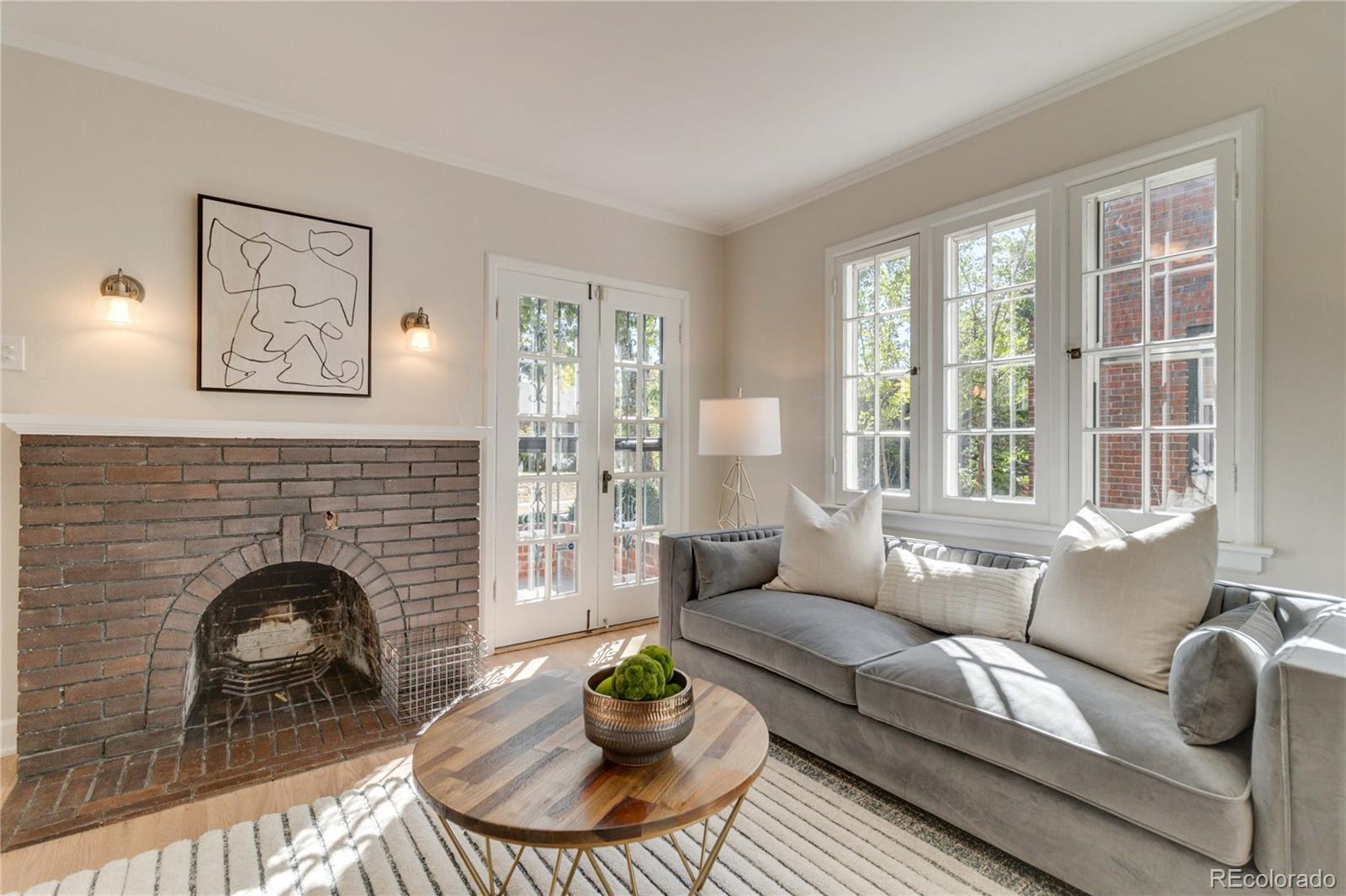 1325 Dahlia Street Denver, CO 80220 - Photo 10 of 44 a living room with furniture a fireplace and potted plants