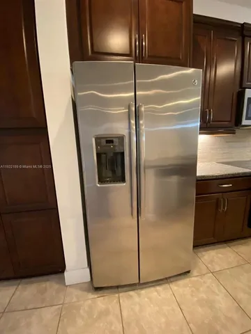 a bathroom with a granite countertop sink and a bathtub