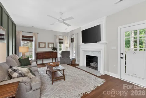 a living room with furniture a flat screen tv and a fireplace