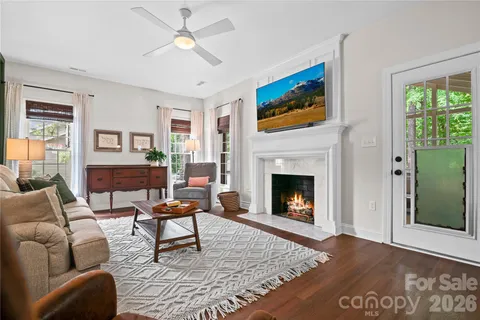 a living room with furniture a fireplace and a table