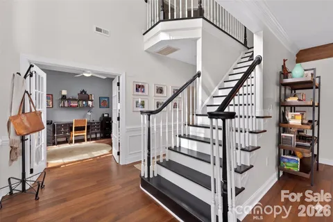 a view of entryway and hall with wooden floor