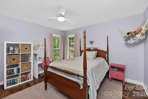 a bed room with a bed and a book shelf