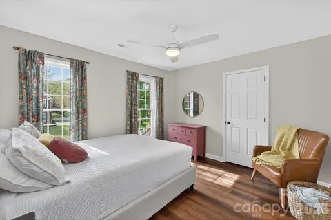 a bedroom with a bed chair and a window
