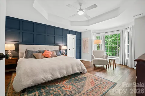 a bedroom with bed and wooden floor