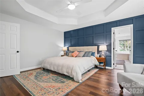 a bedroom with a large bed and a rug
