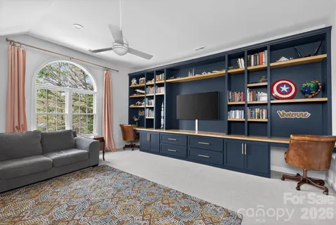 a living room with furniture cabinets and window