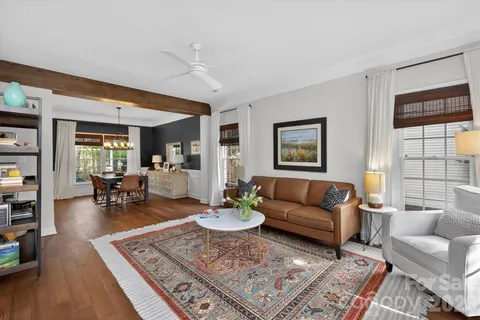 a living room with furniture a rug and a large window
