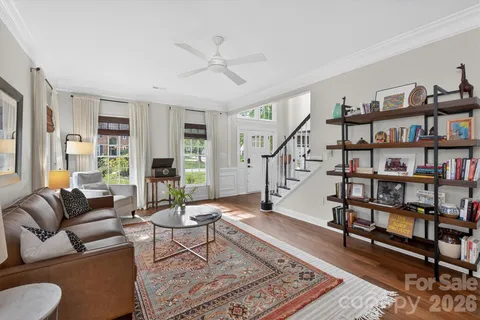 a living room with furniture and a book shelf