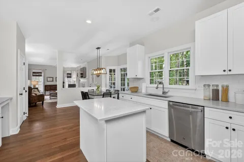 a kitchen with sink stove and cabinets